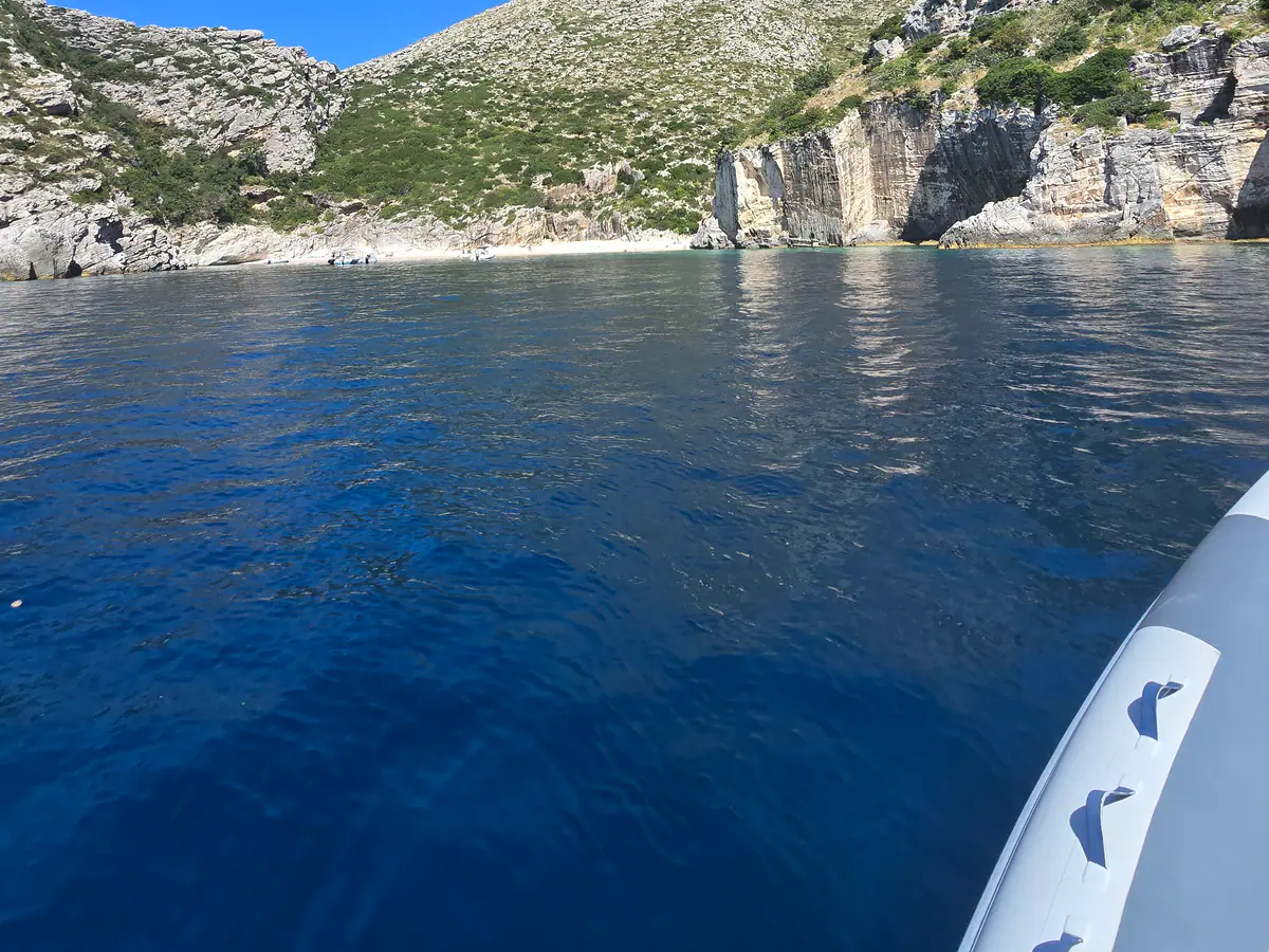 Karaburun cliffs and blue water seen from the boat